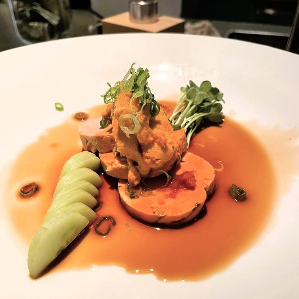 Shiso Noodle and Sushi Bar's foie gras dish with uni, microgreens, and cucumber in a rich sauce.